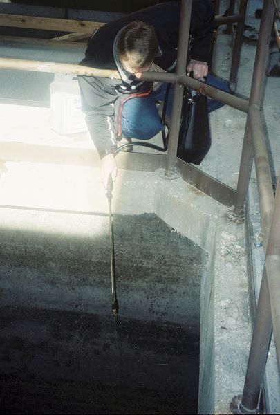 2/6 Applying OSE II down 15 feet to the waste, grease and oil covered inlet surface from a second area at the Trinity River Waste Treatment plant