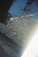 2/7 The waste, grease and oil started reducing and covered a smaller area as time passed; there was a Bboard that flowed into the inlet that seemed t