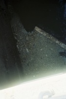 2/8 The waste, grease and oil started reducing and covered a smaller area as time passed; there was a board that flowed into the inlet that seemed to