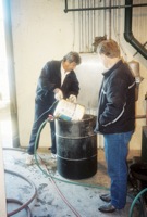 1 Trinity River Waste treatment plant personal pouring waste, oil, and grease into a 55 gallon drum in order to test OSE II